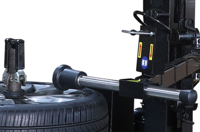 A pneumatic bead assist positioned above a wheel assembly